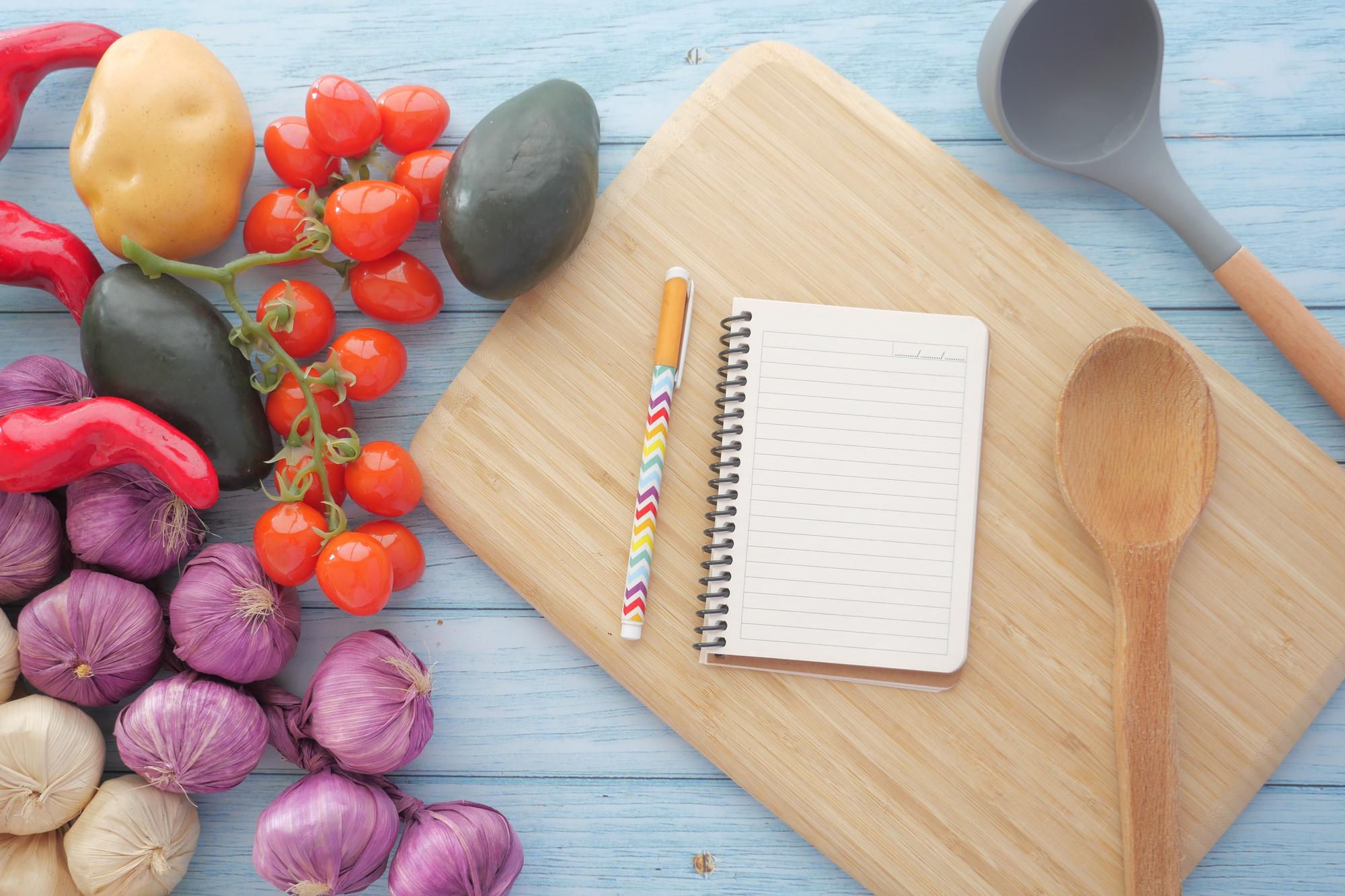 notebook with recipe notes and measuring spoons